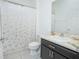 Bathroom featuring modern fixtures, a shower with curtain, and single sink vanity at 171 Seville Dr, Davenport, FL 33837