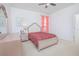 Bedroom with a bed, dresser, and end tables, accented with pink decor at 171 Seville Dr, Davenport, FL 33837