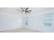 Spacious bedroom with carpet, ceiling fan, and two windows for ample natural light at 171 Seville Dr, Davenport, FL 33837