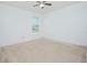 Bedroom with ceiling fan, neutral carpet, and bright natural light, making the room feel large at 171 Seville Dr, Davenport, FL 33837