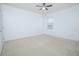 Bright, carpeted bedroom with a ceiling fan and natural light from a window at 171 Seville Dr, Davenport, FL 33837