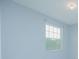 Cozy bedroom with light-blue walls and a bright window at 171 Seville Dr, Davenport, FL 33837