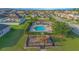Community pool with playground, lounge chairs, picnic tables, and neatly trimmed hedges at 171 Seville Dr, Davenport, FL 33837