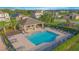 Community pool featuring lounge chairs, tables, and a covered seating area for relaxation and enjoyment at 171 Seville Dr, Davenport, FL 33837