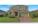 Charming two-story home with a well-manicured lawn and a two-car garage at 171 Seville Dr, Davenport, FL 33837