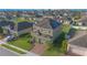 Two-story home featuring a brick driveway, attached garage, solar panels, and well-maintained landscaping at 171 Seville Dr, Davenport, FL 33837