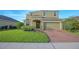 Charming two-story home with a well-manicured lawn and a two-car garage at 171 Seville Dr, Davenport, FL 33837