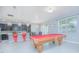 Open concept game room featuring a pool table, kitchen bar, and tile floors at 171 Seville Dr, Davenport, FL 33837