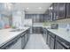 Modern kitchen with stainless steel appliances, white countertops, and dark cabinets at 171 Seville Dr, Davenport, FL 33837