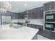 Modern kitchen with dark cabinets and a quartz countertop island at 171 Seville Dr, Davenport, FL 33837