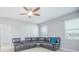 Living room with a sectional couch, ceiling fan, and natural light, perfect for relaxing at 171 Seville Dr, Davenport, FL 33837