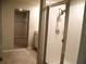Tiled bathroom with glass-enclosed shower and view into the walk-in closet at 17305 Cagan Crossings Blvd, Clermont, FL 34714