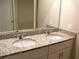 Bathroom featuring double sinks with granite countertops and modern fixtures at 17305 Cagan Crossings Blvd, Clermont, FL 34714