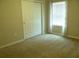 Comfortable bedroom with closet and window with curtains, ready for personalization at 17305 Cagan Crossings Blvd, Clermont, FL 34714
