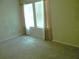 Bright bedroom featuring neutral carpet and a window with stylish curtains at 17305 Cagan Crossings Blvd, Clermont, FL 34714
