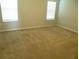 Spacious bedroom featuring neutral carpet and abundant natural light through dual windows at 17305 Cagan Crossings Blvd, Clermont, FL 34714
