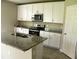 Bright kitchen with granite countertops, stainless steel appliances, and ample cabinet space at 17305 Cagan Crossings Blvd, Clermont, FL 34714