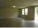 Spacious living room with tile floors, recessed lighting, and sliding door to the backyard at 17305 Cagan Crossings Blvd, Clermont, FL 34714