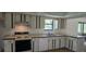 Classic kitchen with vintage cabinets and stove, open to the living area at 2008 Juniper Dr, Edgewater, FL 32141