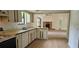 Bright kitchen featuring vintage cabinets and view to living room with fireplace at 2008 Juniper Dr, Edgewater, FL 32141