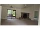 Spacious living room featuring a stone fireplace and sliding glass doors at 2008 Juniper Dr, Edgewater, FL 32141