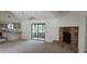 Open-concept living room with a stone fireplace, sliding doors, and views of the kitchen at 2008 Juniper Dr, Edgewater, FL 32141