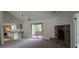 Expansive living room with open access to kitchen, stone fireplace, and screened porch at 2008 Juniper Dr, Edgewater, FL 32141