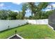 Well-maintained backyard with green grass, a privacy fence, and adirondack seating at 207 Ramsbury Ct, Longwood, FL 32779
