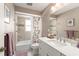 Tiled bathroom with shower-tub combo and decorative tile accents at 207 Ramsbury Ct, Longwood, FL 32779