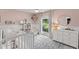 Bright Bedroom featuring a white crib, a window view, and light pink colored walls at 207 Ramsbury Ct, Longwood, FL 32779