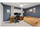 Blue bedroom with large desk, ceiling fan, and natural light at 207 Ramsbury Ct, Longwood, FL 32779