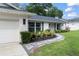 Charming home featuring a freshly painted brick exterior, a garage, and a beautifully landscaped walkway at 207 Ramsbury Ct, Longwood, FL 32779