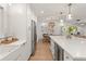 Kitchen featuring white cabinets, stainless steel appliances, quartz countertops, and open to dining area at 207 Ramsbury Ct, Longwood, FL 32779