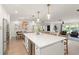 Open concept kitchen with large island, pendant lighting, built-in beverage cooler, and bar stool seating at 207 Ramsbury Ct, Longwood, FL 32779
