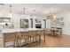 Bright, open floor plan with kitchen island, bar seating, fireplace, and dining area with natural light at 207 Ramsbury Ct, Longwood, FL 32779