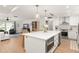 Spacious kitchen with island seating, quartz countertops, stainless appliances and flows to the living room at 207 Ramsbury Ct, Longwood, FL 32779