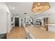 Bright living room with open floor plan and light wood flooring featuring a dining space at 207 Ramsbury Ct, Longwood, FL 32779
