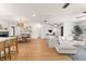 Open floor plan with kitchen island, dining area, and living room with ample natural light at 207 Ramsbury Ct, Longwood, FL 32779