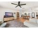 Bright open-concept living room with a large TV, and seamless flow into the kitchen at 207 Ramsbury Ct, Longwood, FL 32779