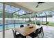 Covered patio featuring a wooden dining table with seating and pool views at 207 Ramsbury Ct, Longwood, FL 32779