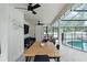 Covered patio boasts a dining table and chairs with seating and comfortable sofas at 207 Ramsbury Ct, Longwood, FL 32779