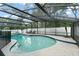 Enclosed pool area featuring a kidney-shaped pool, tiled border, and lounge chairs at 207 Ramsbury Ct, Longwood, FL 32779