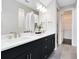 Modern bathroom featuring a double vanity with dark cabinets, quartz countertop, and large mirrors at 2267 Mossy Vine Ave, St Cloud, FL 34771