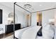 Comfortable bedroom showcasing a stylish bed, modern decor, and a view of the closet and ensuite bathroom at 2267 Mossy Vine Ave, St Cloud, FL 34771