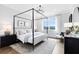 Serene bedroom with a four-poster bed, neutral tones, and ample natural light at 2267 Mossy Vine Ave, St Cloud, FL 34771