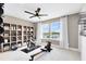 Bright exercise room featuring exercise equipment, ceiling fan, large windows and ample storage at 2267 Mossy Vine Ave, St Cloud, FL 34771