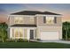 Charming two-story home with a neutral color scheme, two-car garage and lush landscaping at 2267 Mossy Vine Ave, St Cloud, FL 34771