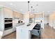 Spacious kitchen features a center island, stainless appliances and pendant lighting at 2267 Mossy Vine Ave, St Cloud, FL 34771