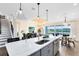 Open-concept kitchen with a large island, flowing into the living and dining areas at 2267 Mossy Vine Ave, St Cloud, FL 34771