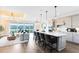 Modern, open-concept kitchen with large island, pendant lighting and a view of the living room at 2267 Mossy Vine Ave, St Cloud, FL 34771